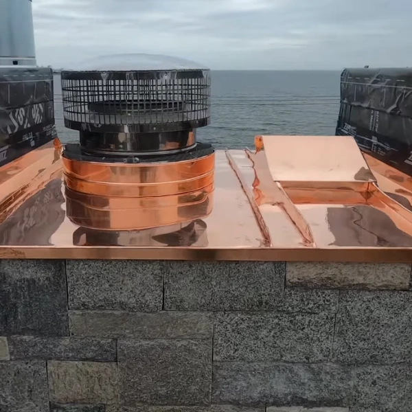 Beautiful copper chimney cap installation showing patina option