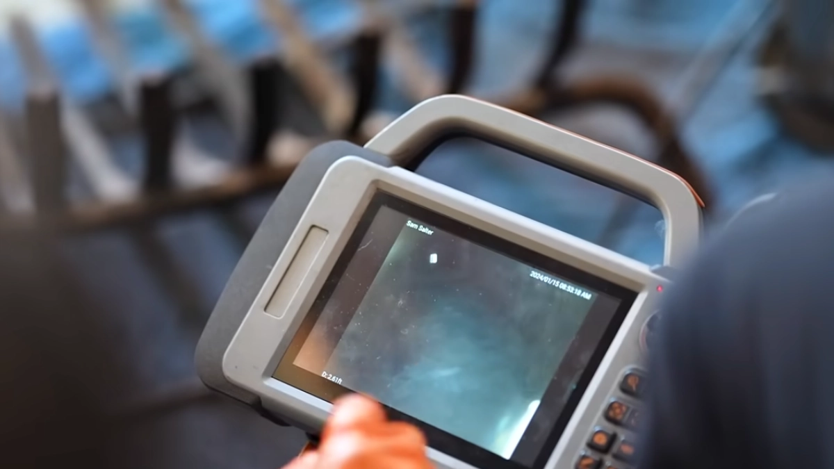 Certified chimney technician performing a masonry check using video scanning