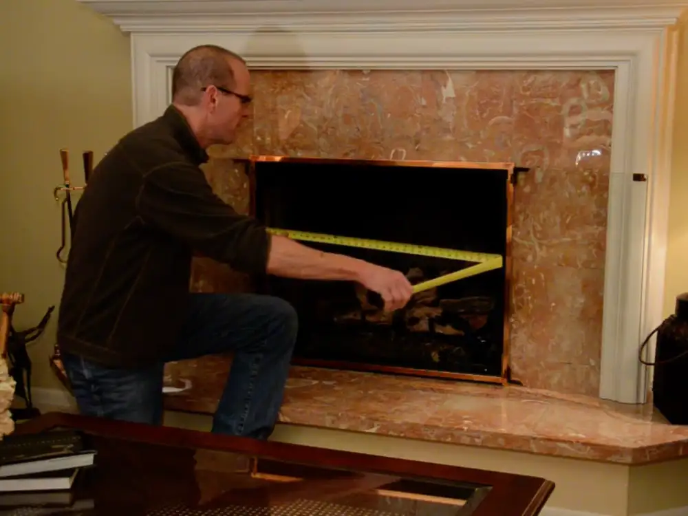 Technician measuring clearance distances for wood stove