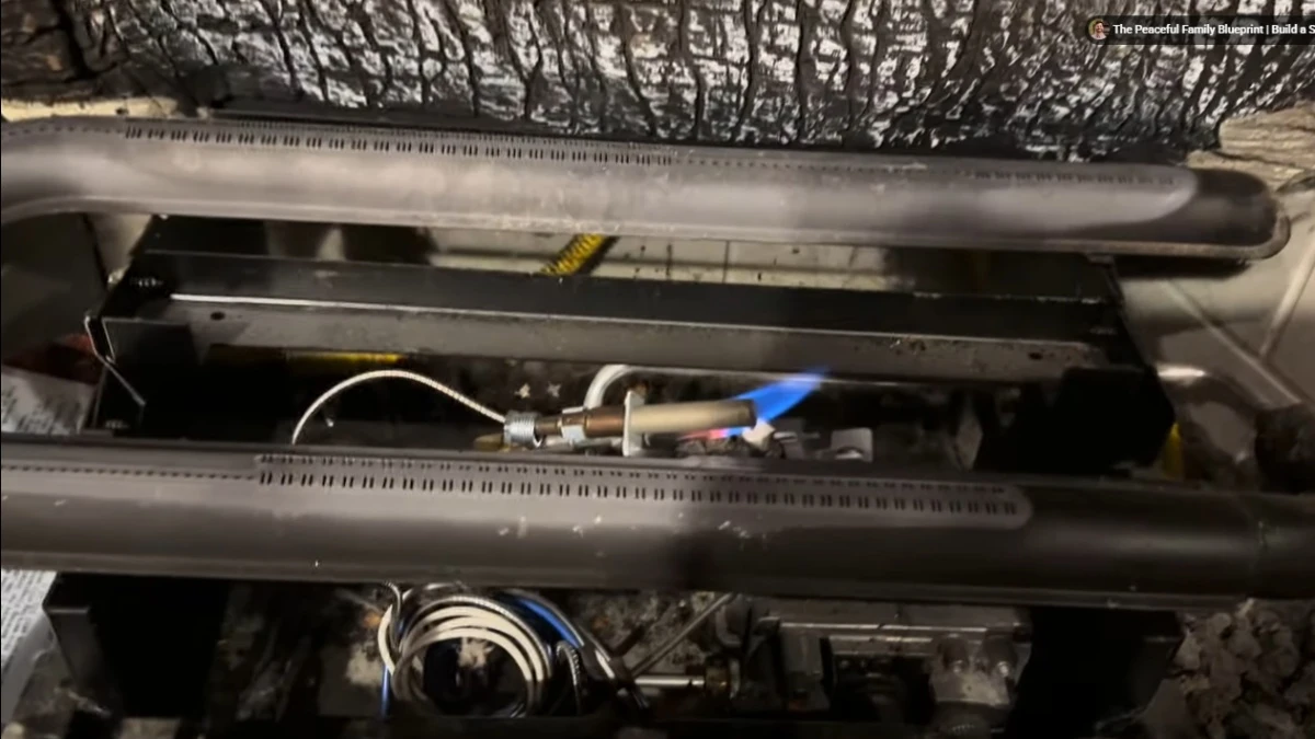Certified fireplace technician checking gas burner valve